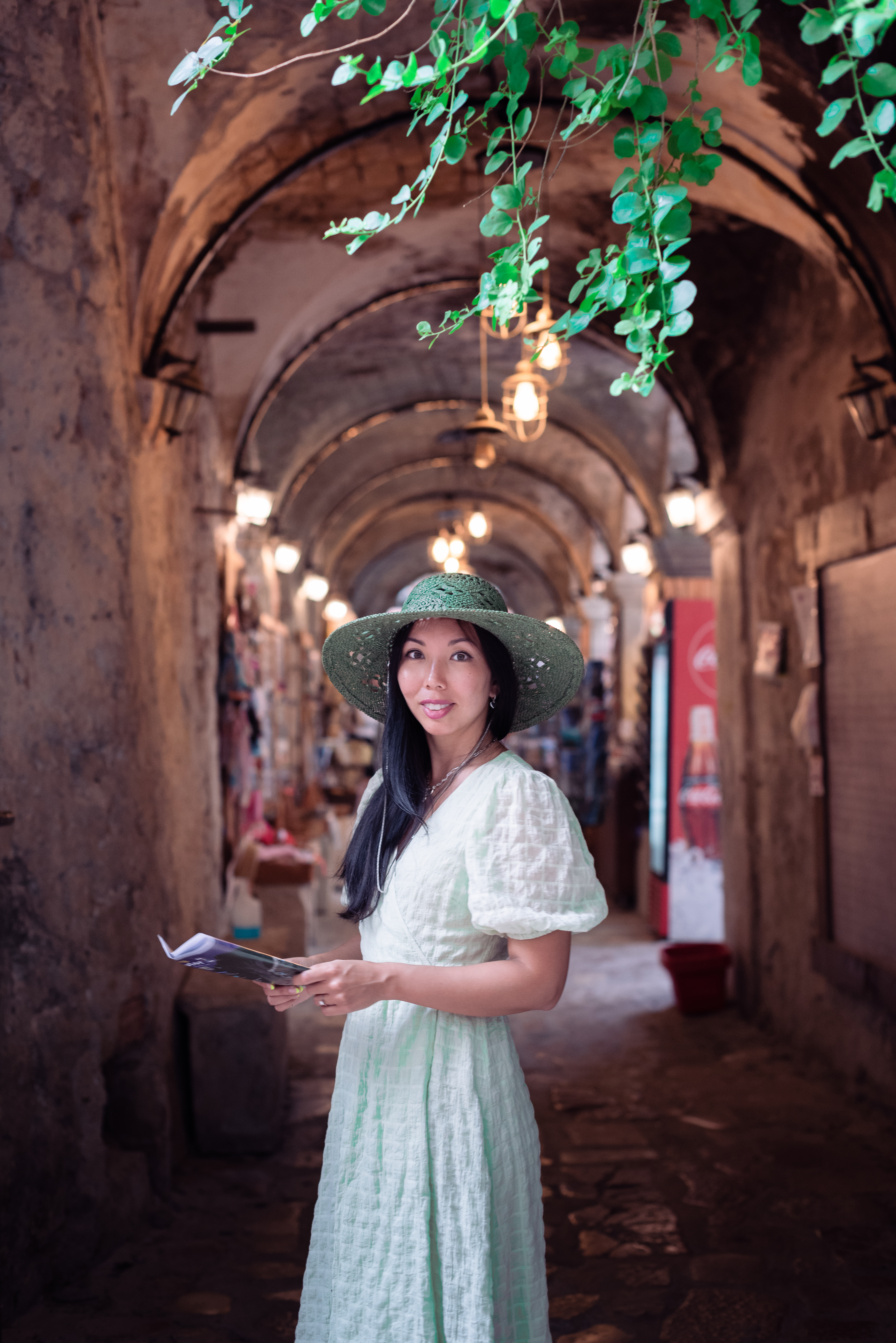 a girl standing in the middle of a beautiful street in town Kotor,Montenegro,where the walls are made of stones.