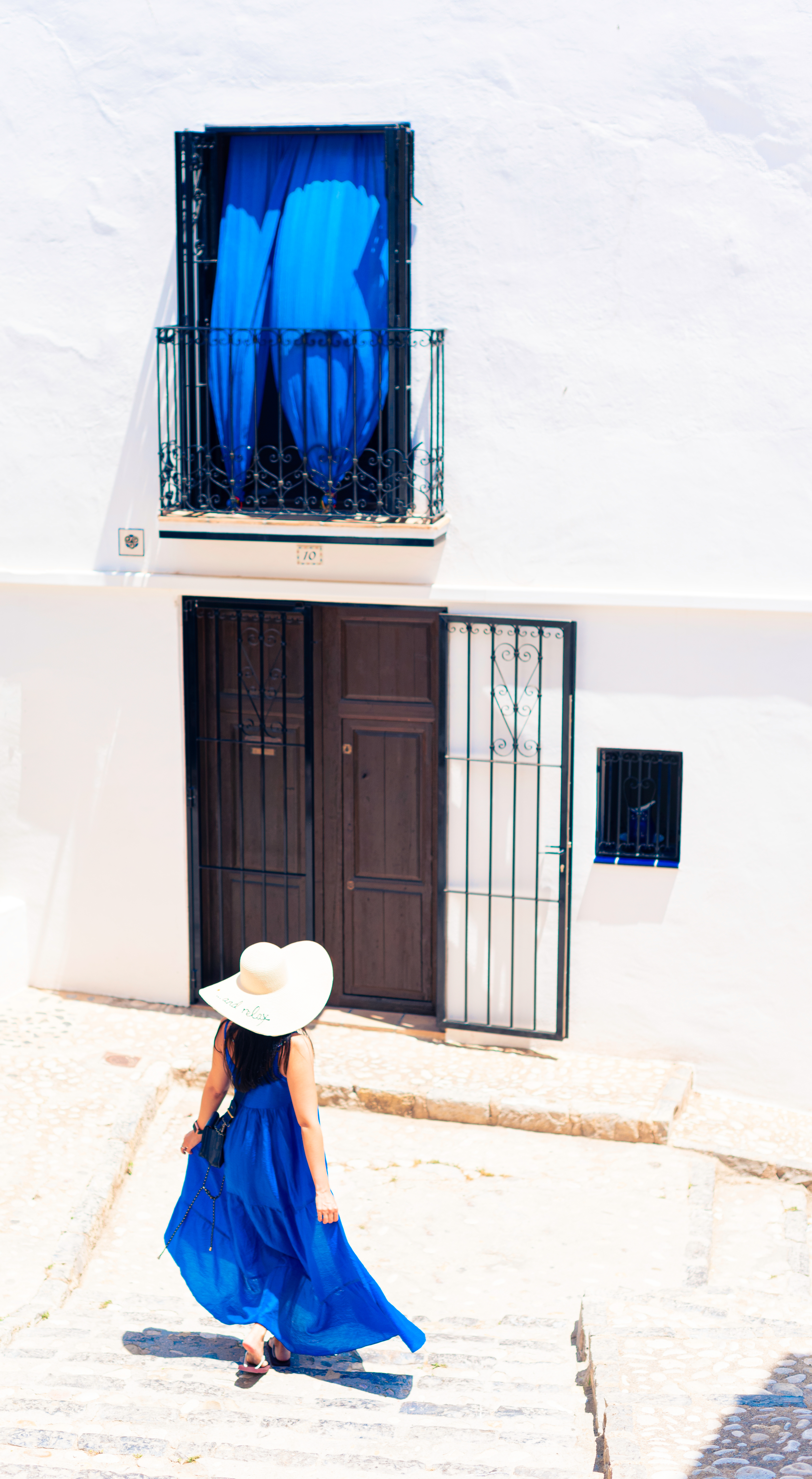 a girl walking down the stairs in an old village